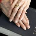 Senior woman's hands on a Bible